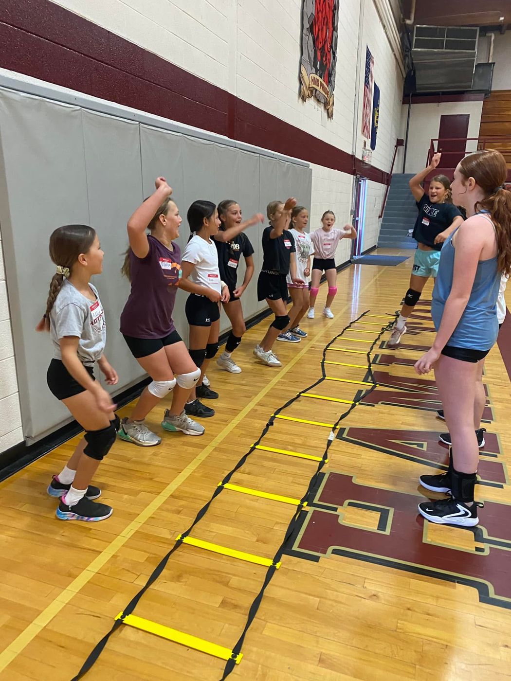 Players running footwork drills on an agility ladder